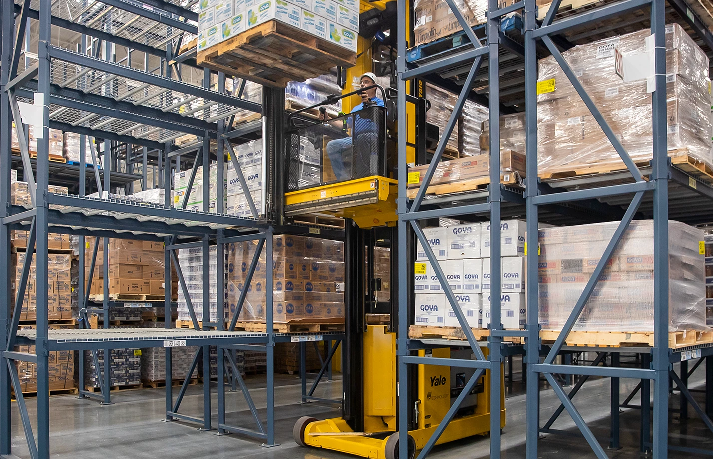 A customized Yale lift truck lifting a pallet in a Goya Foods warehouse.