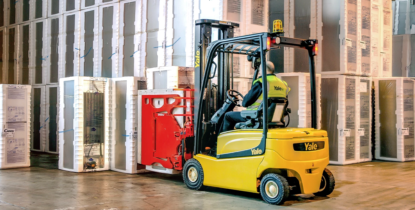 Yale forklift with Bolzoni appliance clamp transporting refrigerators. 