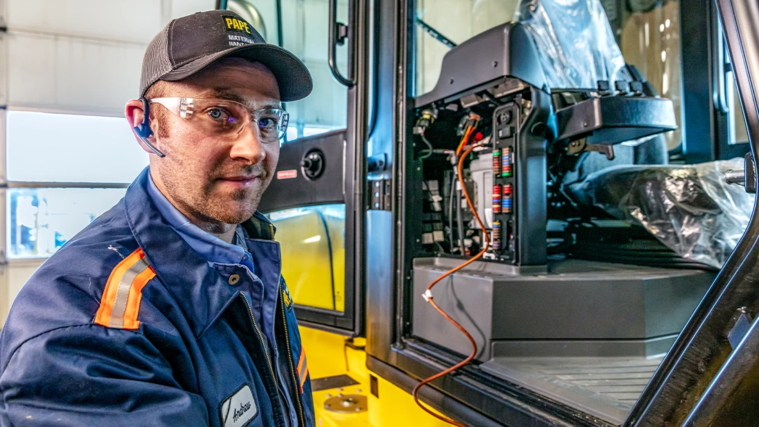 Pape service technician performing maintenance on Hyster forklift. 