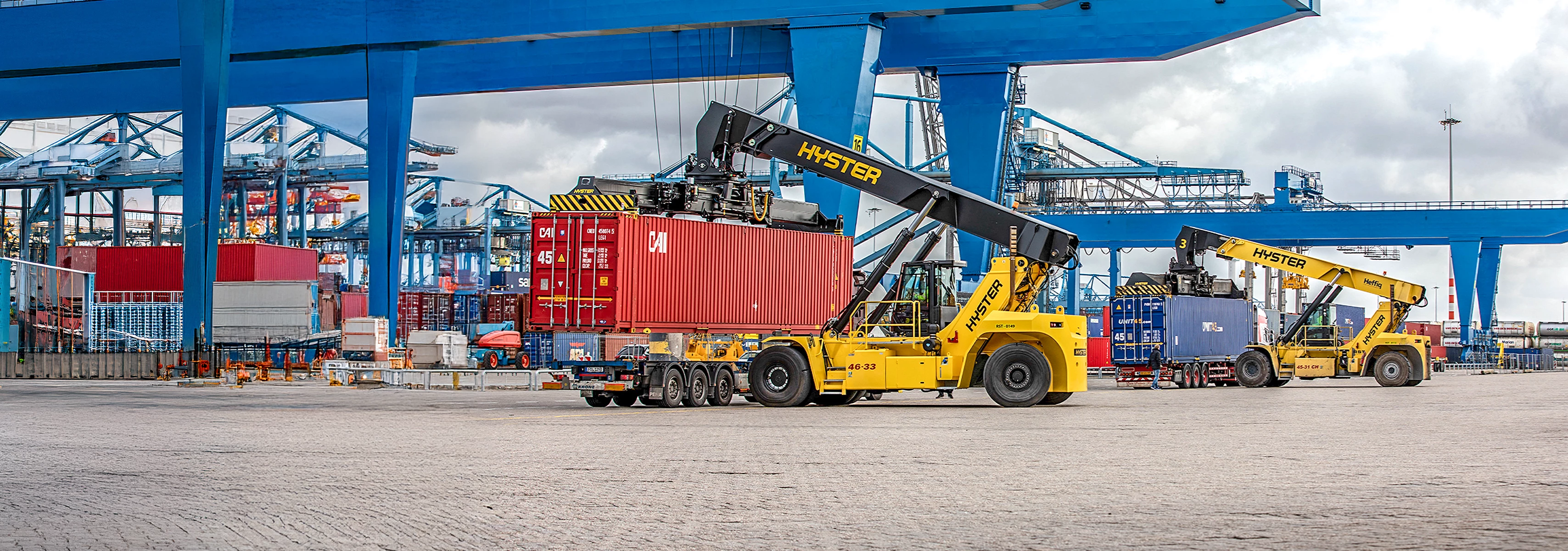 Hyster ReachStackers working moving containers in a port.