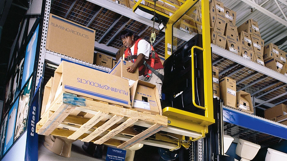 Person picking orders on Yale order picker in home center. 
