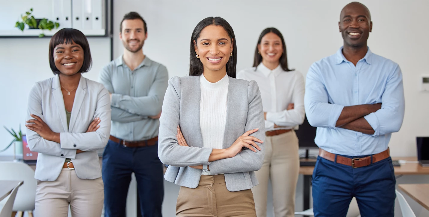 Group of people standing and smiling together.