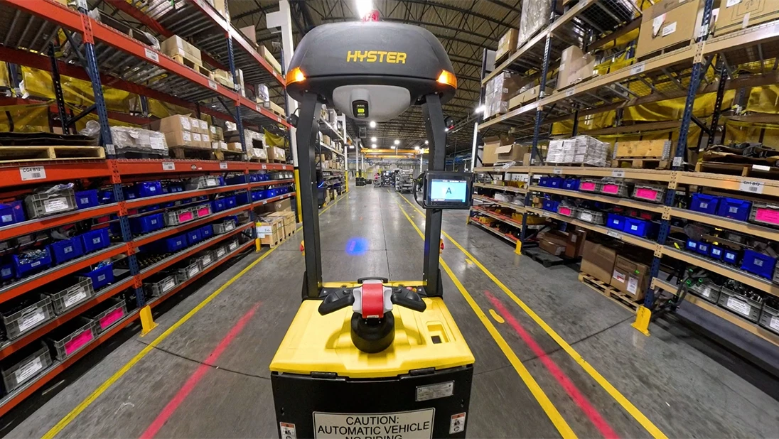 Hyster Atlas automated lift truck traveling through manufacturing facility.