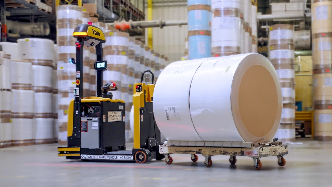 Yale Relay automated lift truck pulling load in warehouse. 