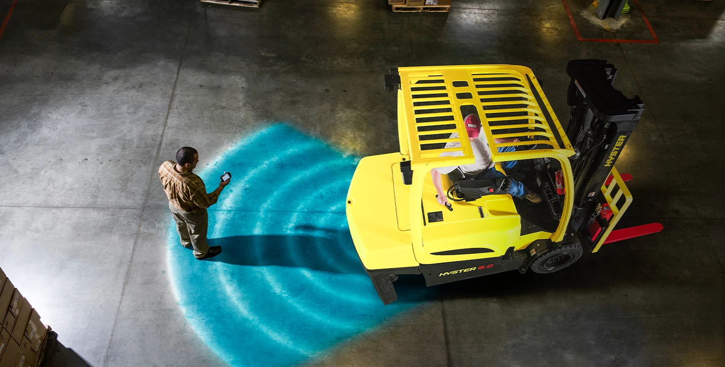 Hyster forklift with Hyster Reaction operator assist technology notifying operator and pedestrian of a risky situation.